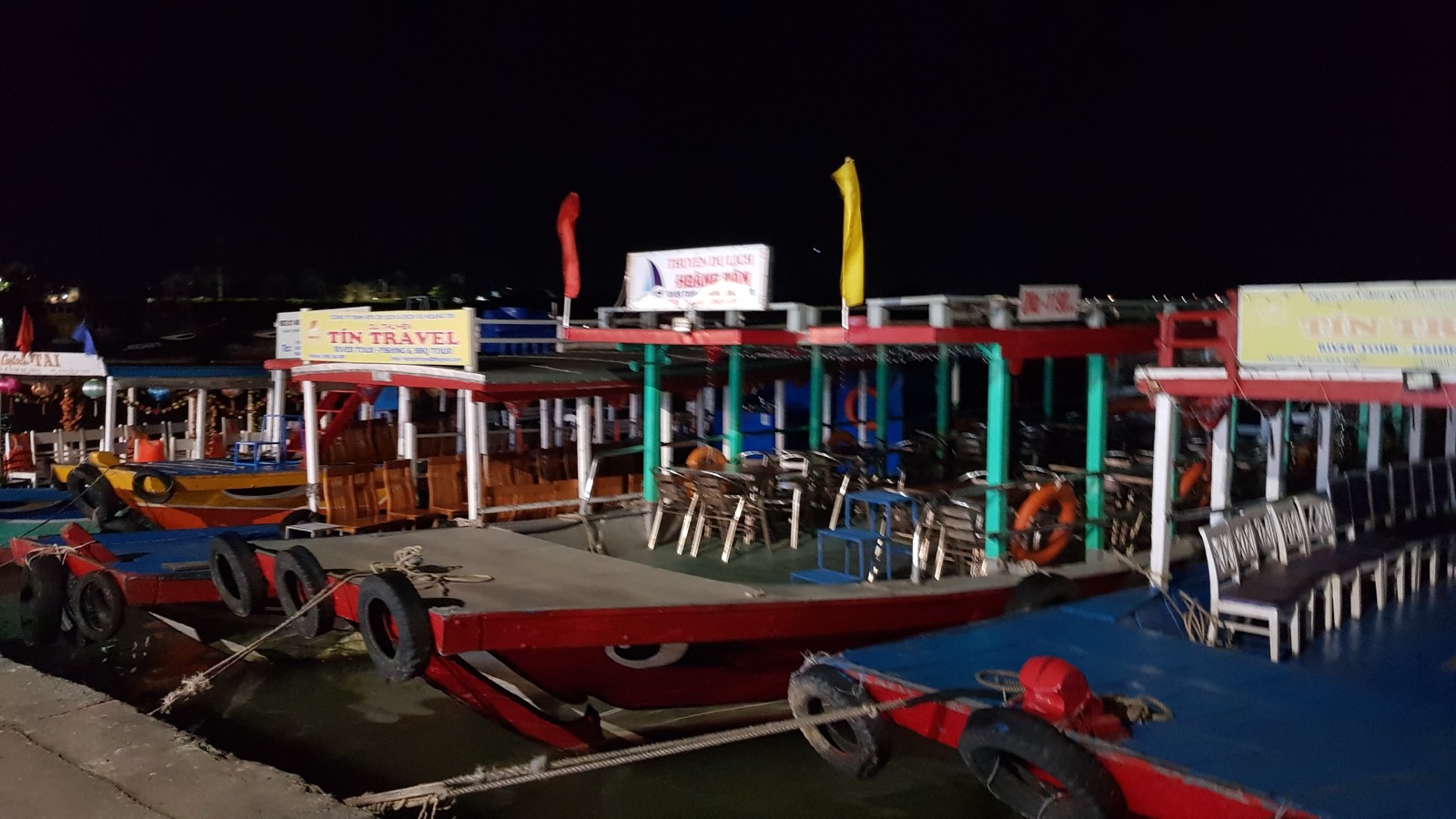 Boats moored along the river in Hoi An at night
